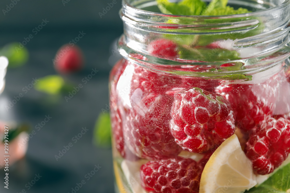 Glass jar of fresh raspberry mojito, closeup