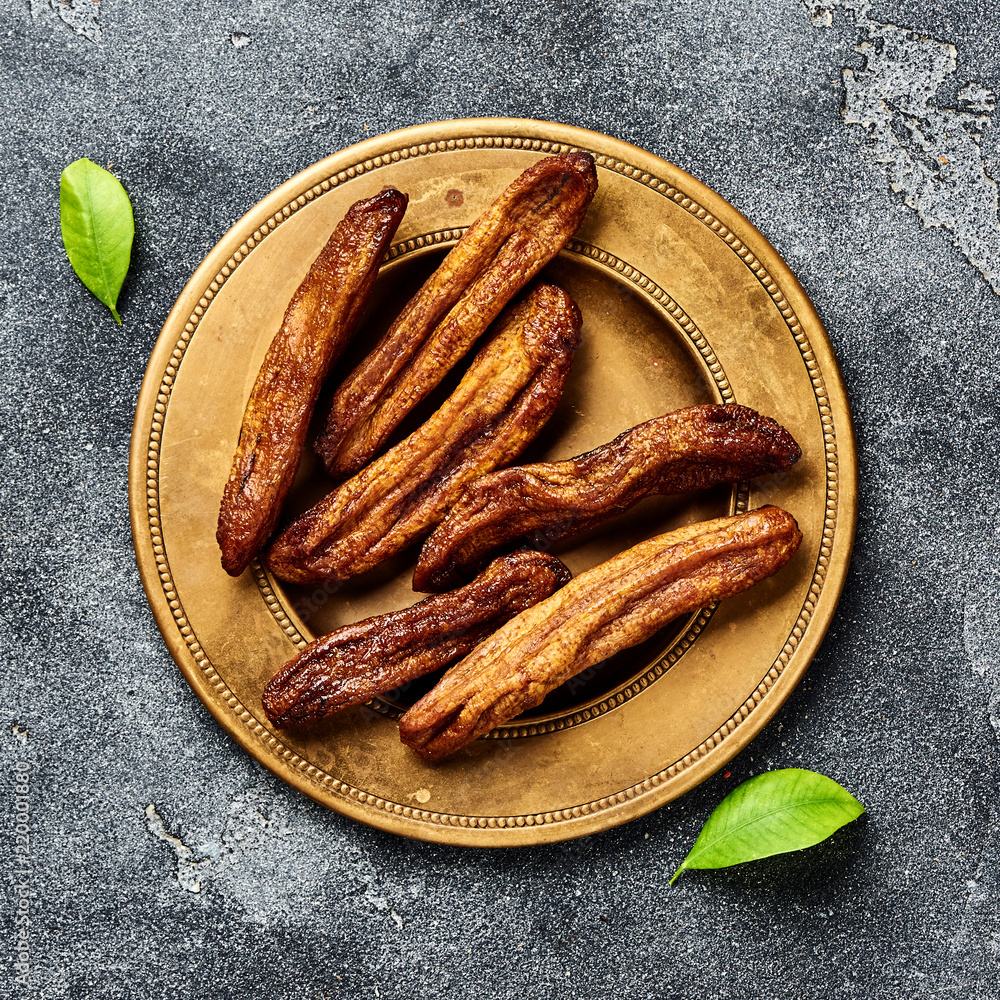 Dried bananas on gray background. Top view.