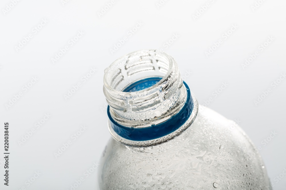 Open Empty Water Bottle on the Grey Background