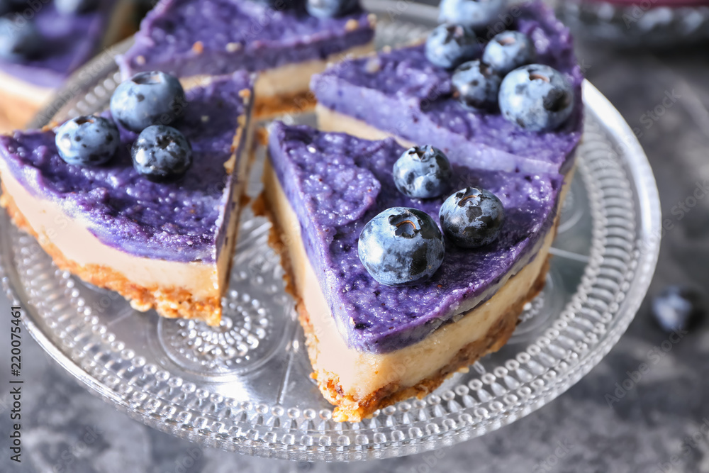 Tasty cheesecake with blueberries on plate, closeup