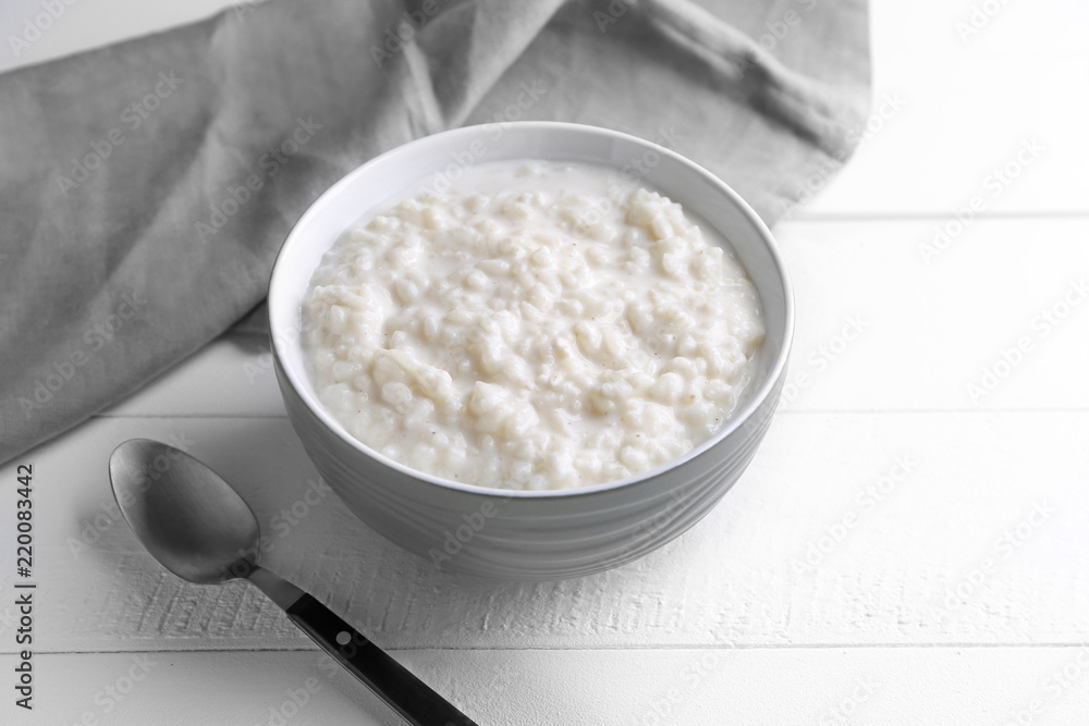 Delicious rice pudding in bowl on white table