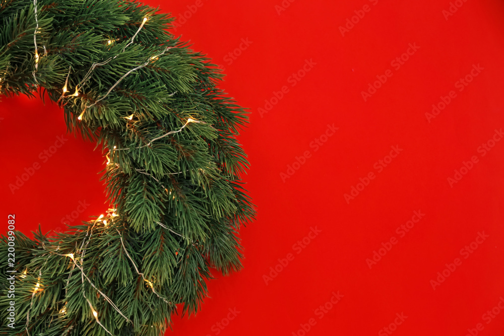 Christmas wreath on color background