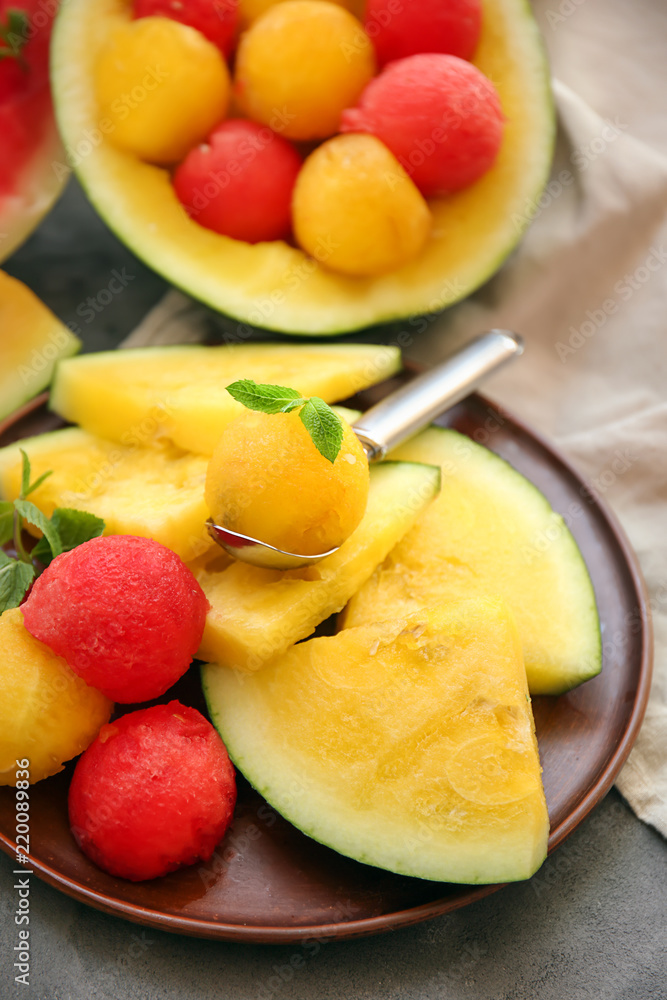 Slices of yellow watermelon with balls on plate