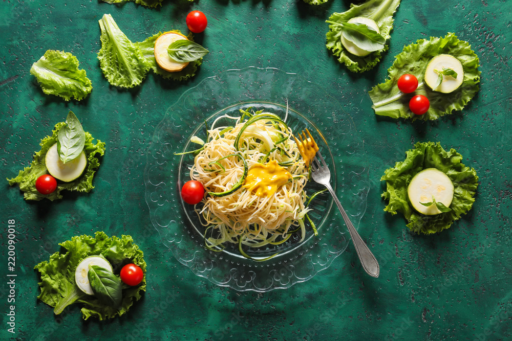 Composition with spaghetti and vegetables on color background