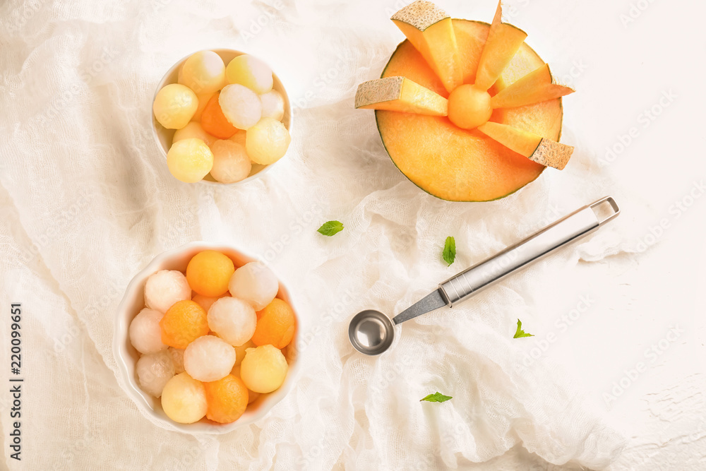 Sliced melon and delicious balls on white table