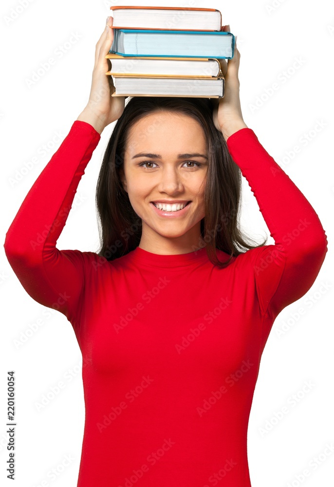 Young woman balancing textbooks on top of her head