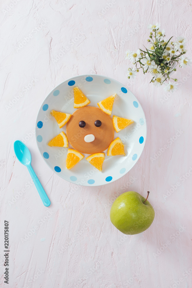 Pancakes with fruit for the children. Top view