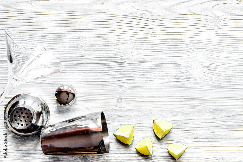 martini and shaker top view of wooden background