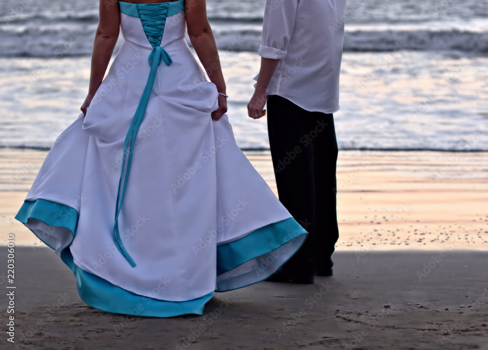 Wave watching wedding couple