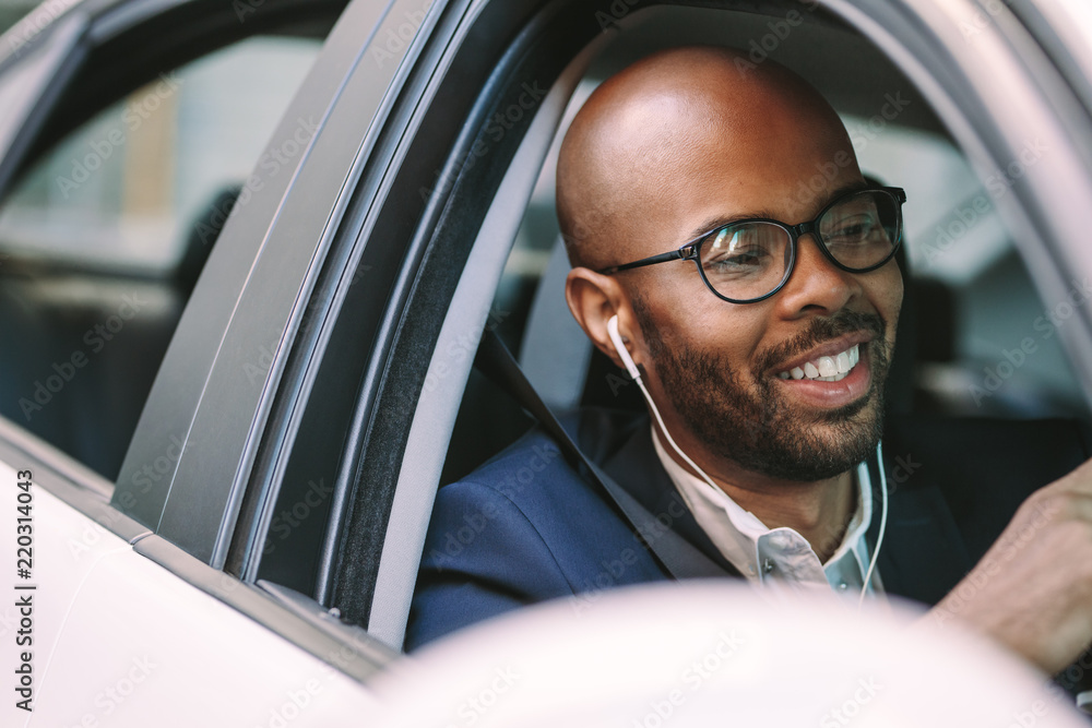 Man smiling inside the car while driving