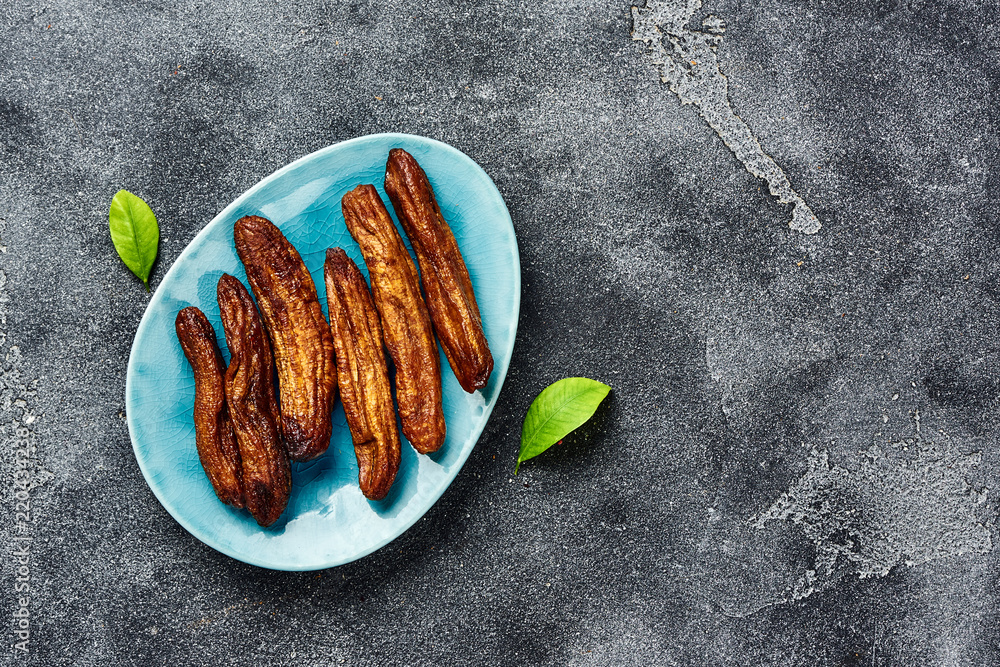 Dried bananas on gray background with copy space. Top view.