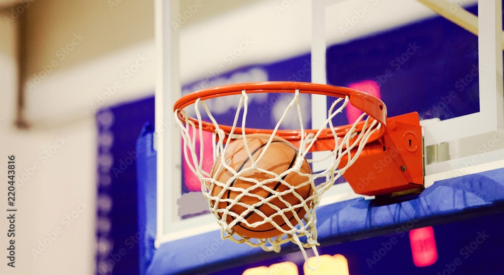 Adidas Basketball ball hitting basket in gym