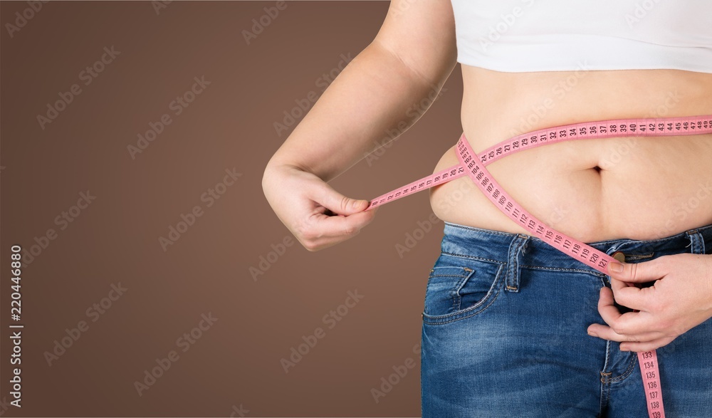 Close-up female figure with measuring tape on blue background