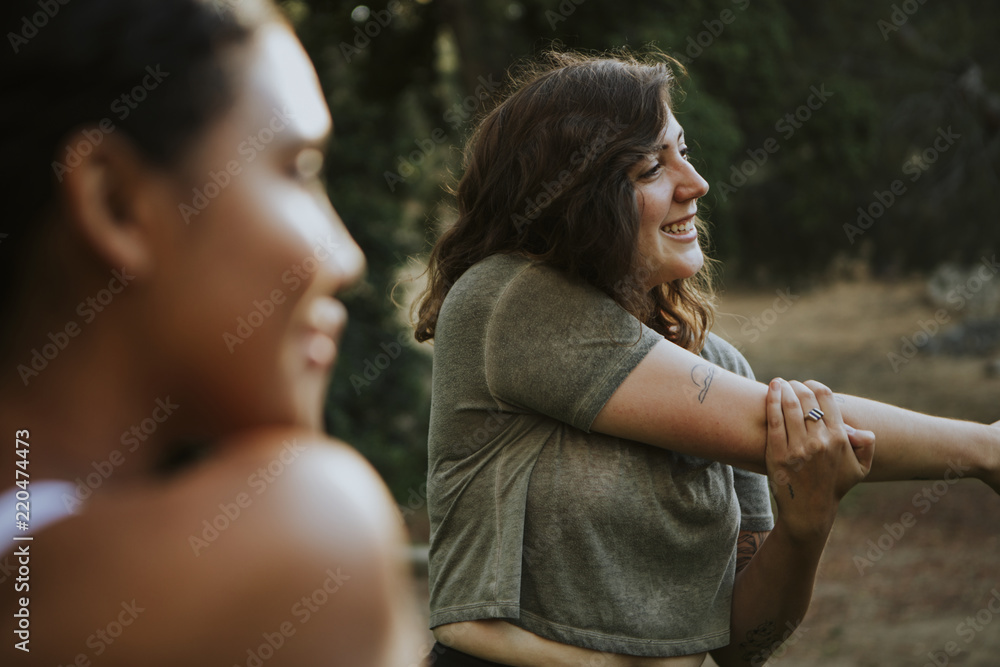 Friends stretching together in the park