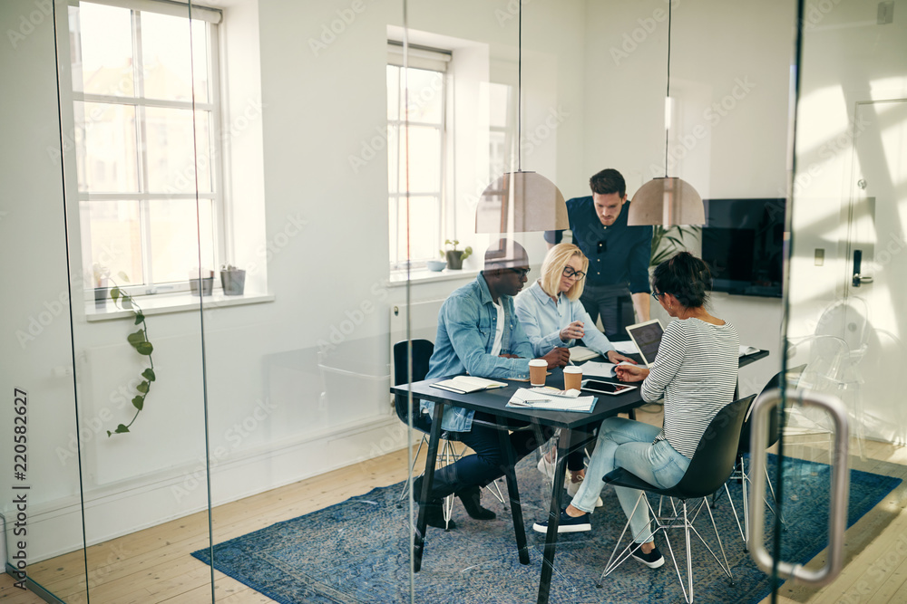 Diverse young businesspeople discussing work together in an offi