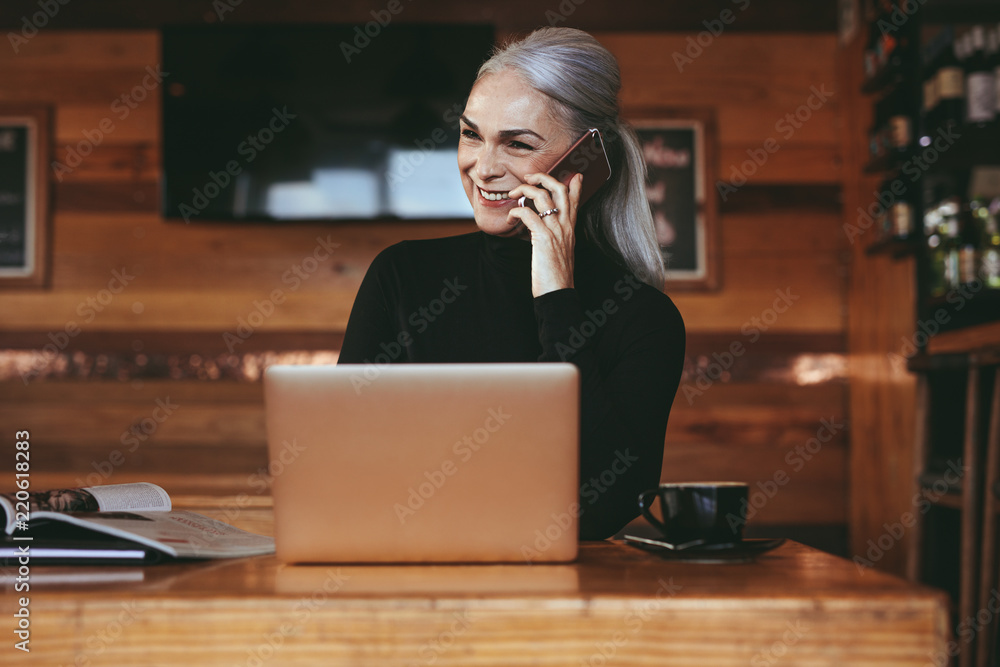 Businesswoman at cafe making a phone call