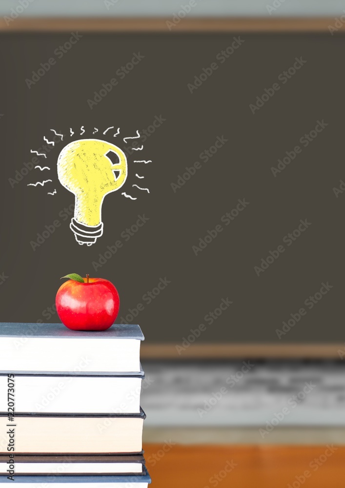 Light bulb floating over apple on books with blackboard