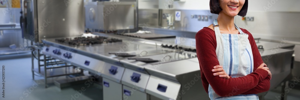 Composite image of smiling waitress standing with arms crossed