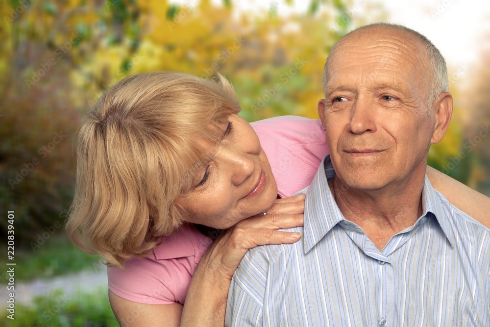 Portrait of happy senior couple smiling  in park