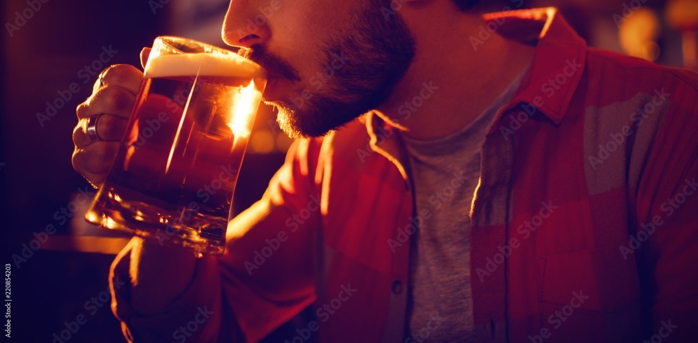 Young man having mug of beer 