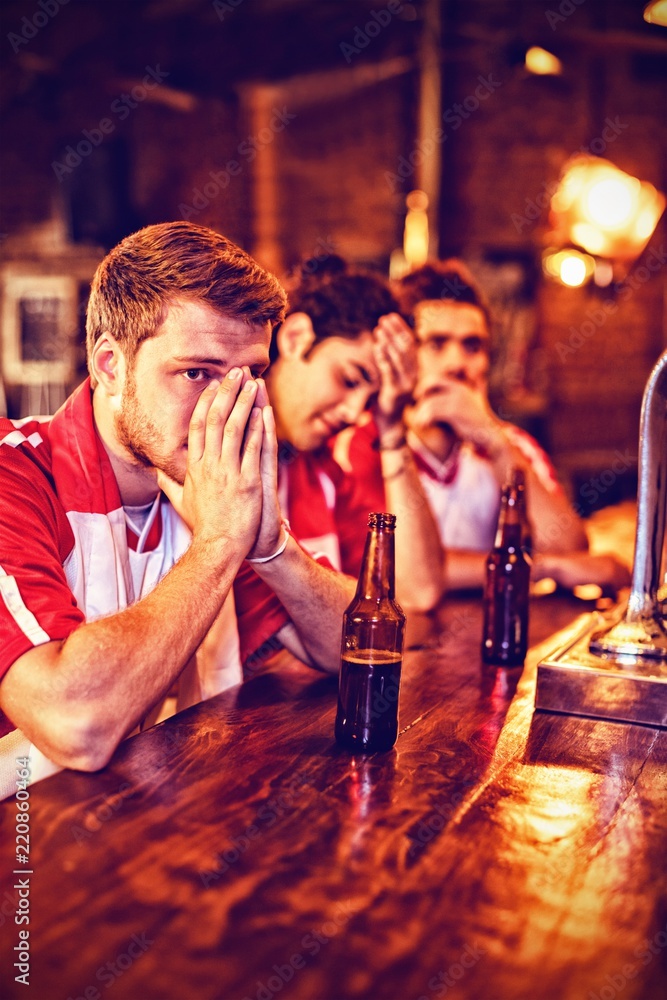 Group of male friends watching football match