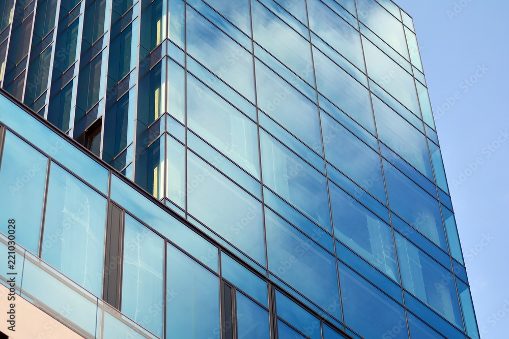 Abstract fragment of contemporary architecture, walls made of glass and concrete. Glass curtain wall