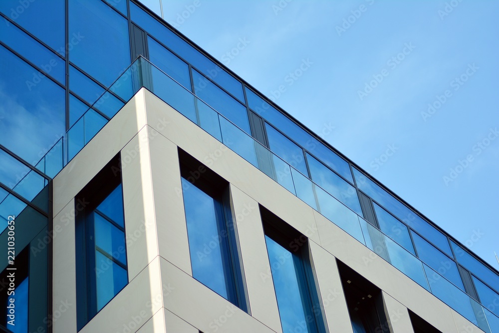 Abstract fragment of contemporary architecture, walls made of glass and concrete. Glass curtain wall