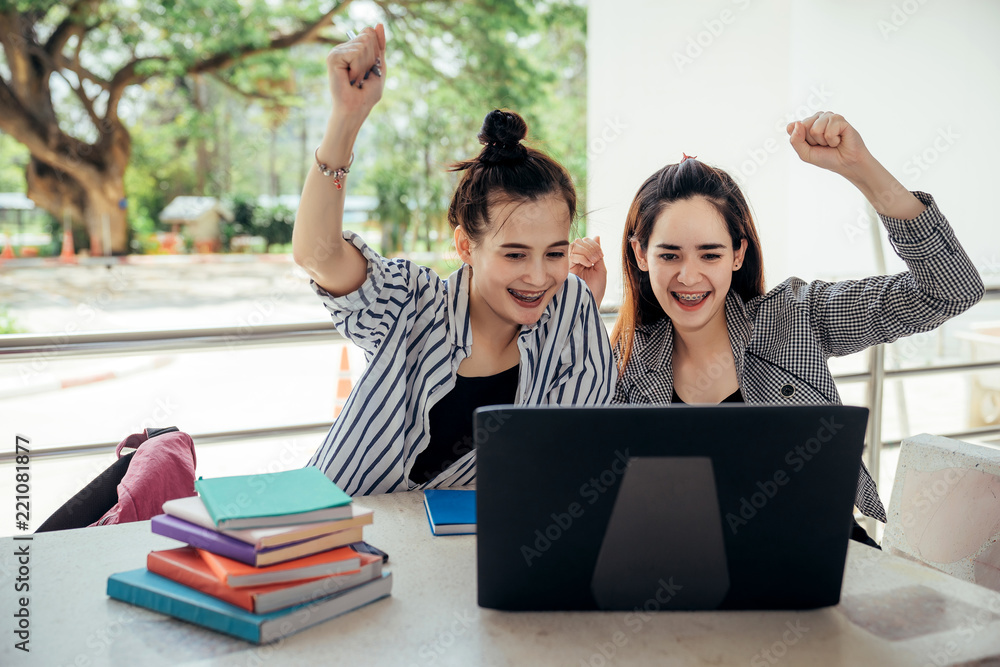 A group of teenage student in university smiling and using the laptop to learning the reason and doi