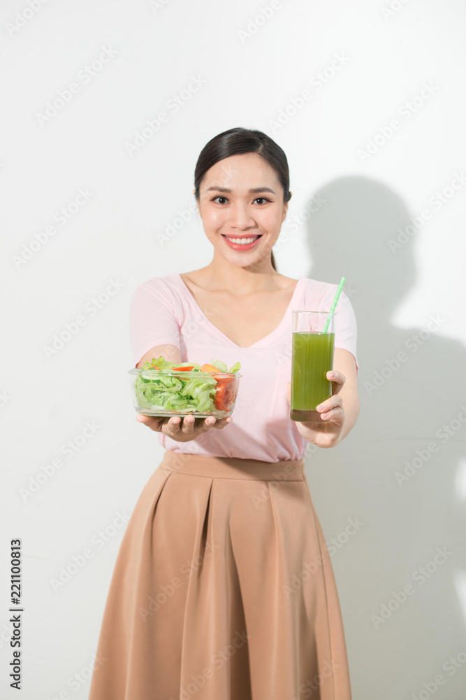 Woman with green detox smoothies, salad in glass bowl isolated on white background. Proper nutrition