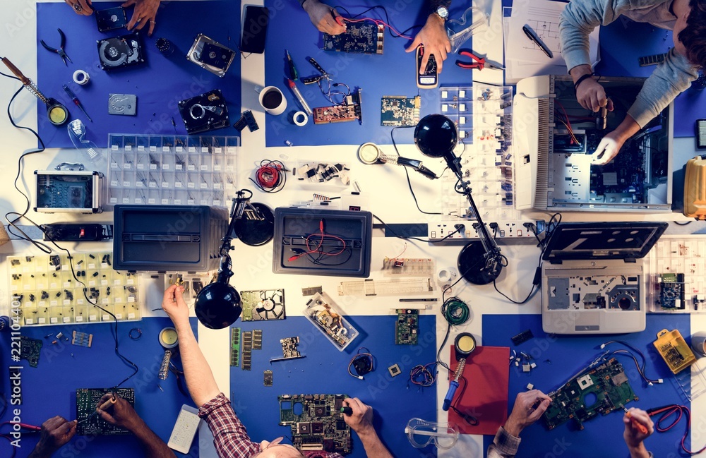 Aerial view of electronics technicians team working on computer parts