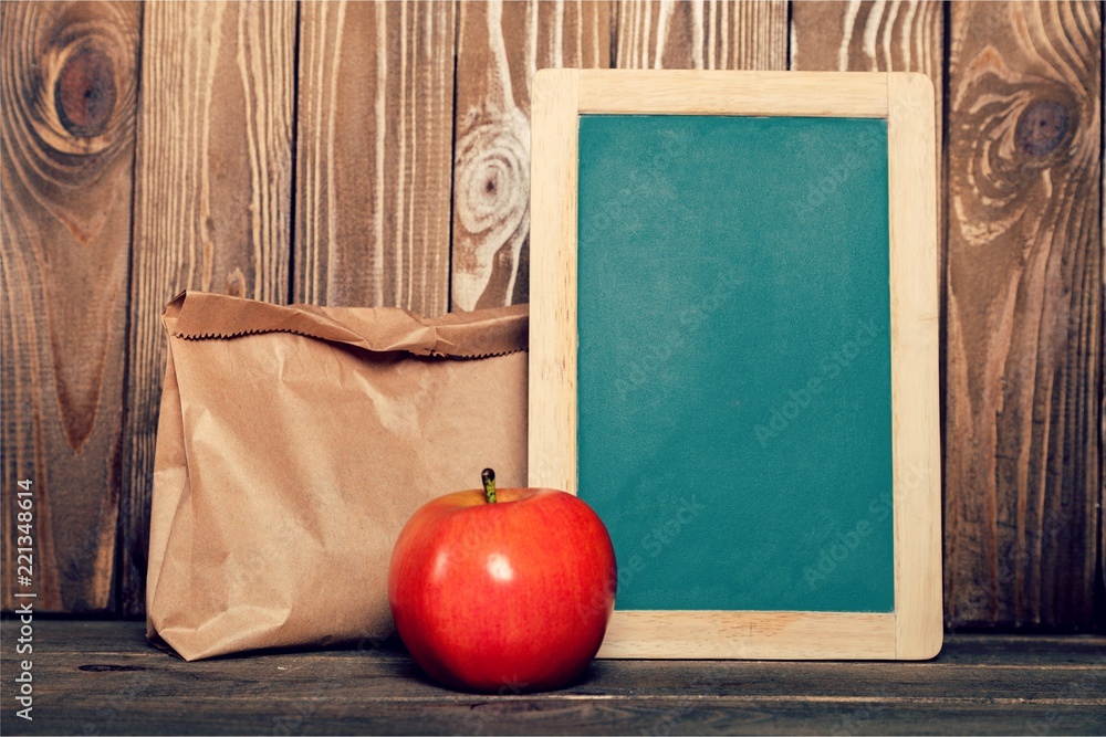 Paper bags in row against blackboard background