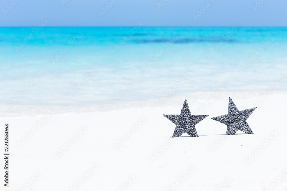 Stars decorations on sandy beach, greeting card