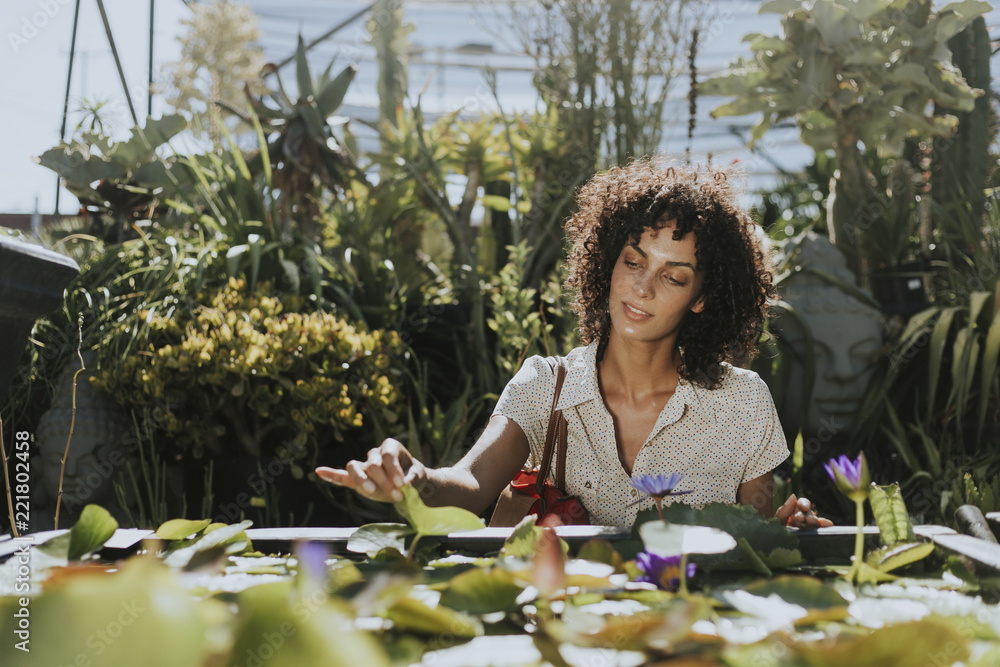 Beautiful woman by a lotus pond