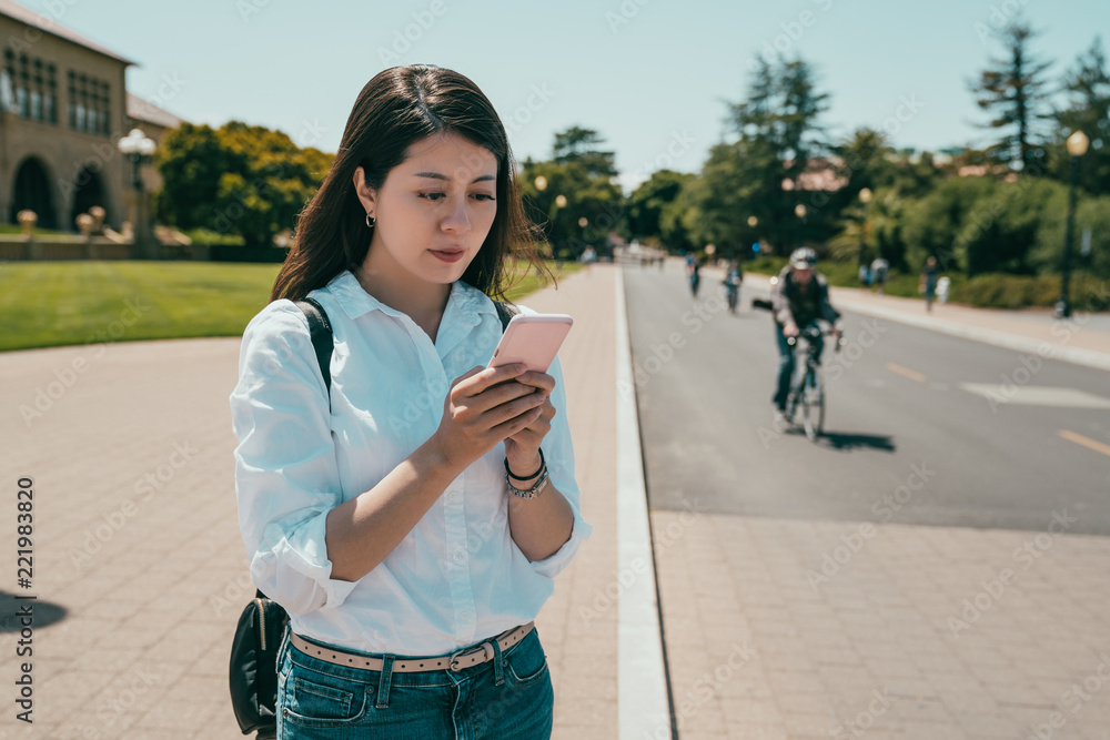 student searching on a phone while crossing