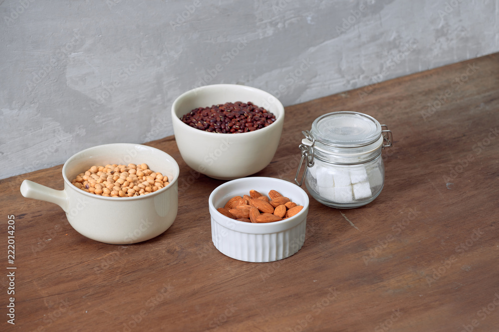 Varieties of nuts: soy nuts, hazelnuts and red beans with sugar in glass jar. Food and cuisine.