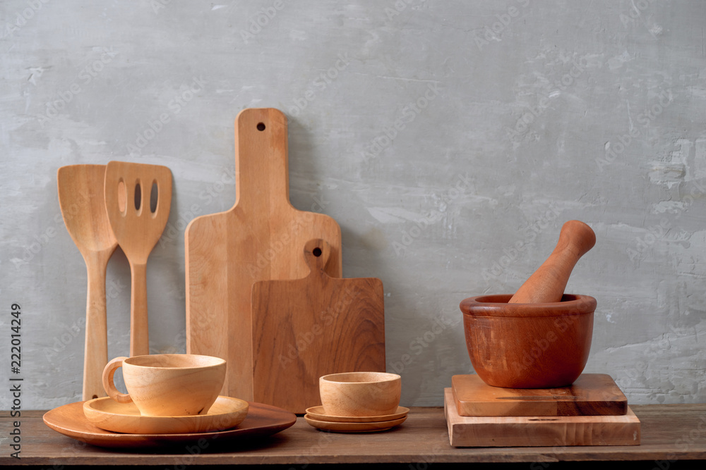 Kitchen tools, olive cutting board on a kitchen shelf against a white brick wall. Selective focus