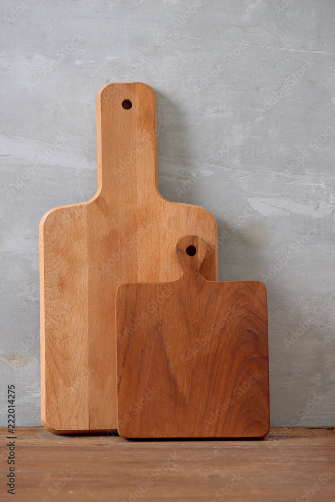 Kitchen tools for cooking on a wooden table on the background of a concrete wall. Copy space