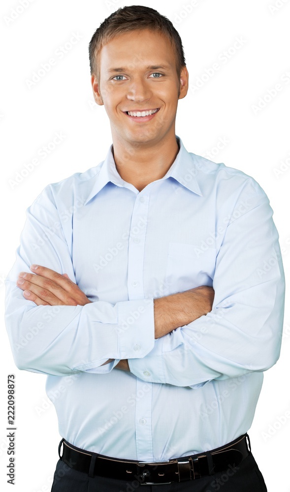 Professional looking man with his arms crossed wearing a button