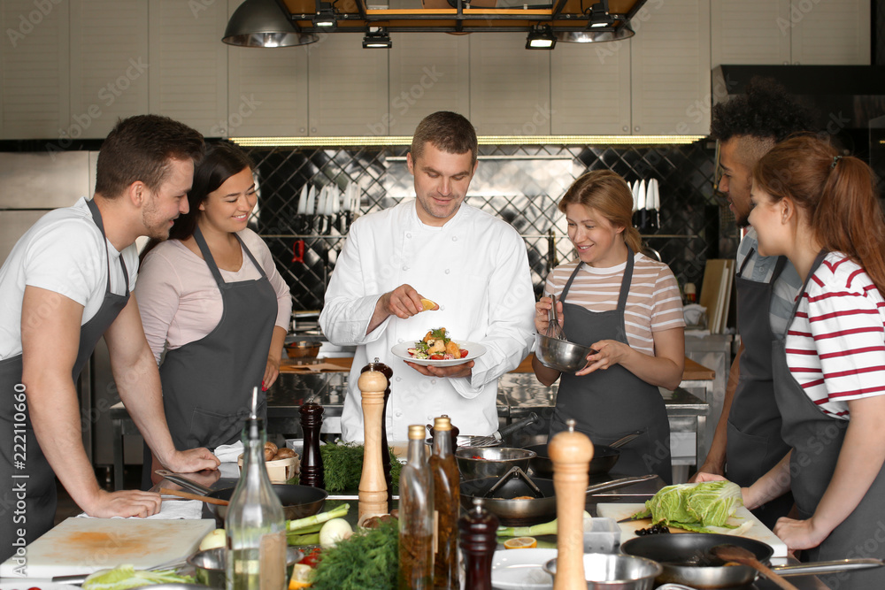 Chef and group of young people during cooking classes