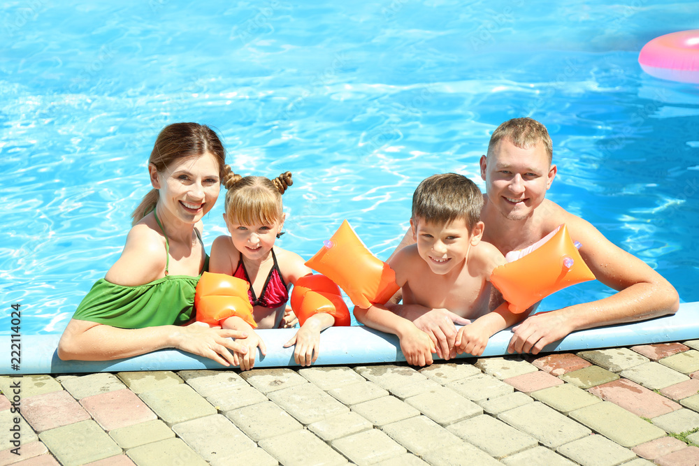 Happy family resting in swimming pool