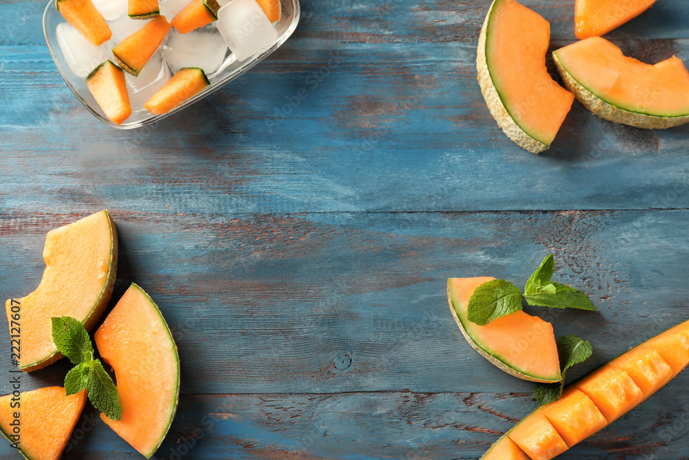 Composition with cut ripe melon on wooden table