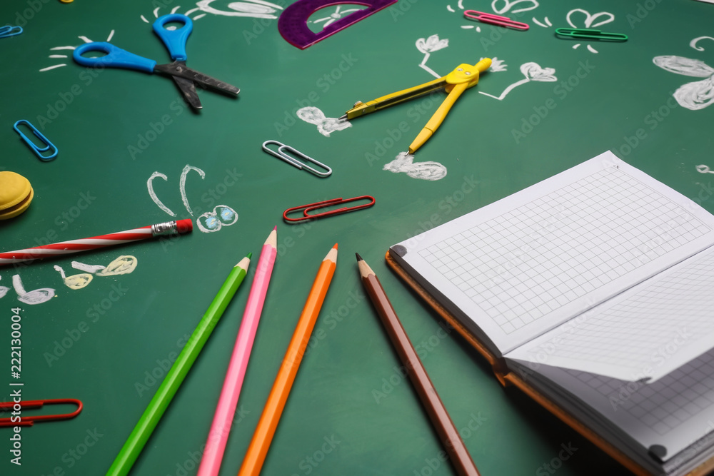 Creative composition with school stationery on chalkboard