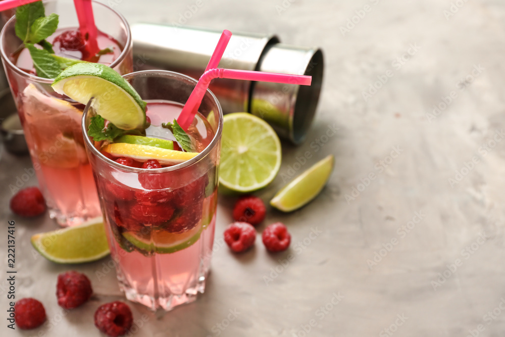 Glasses of fresh raspberry mojito on light table