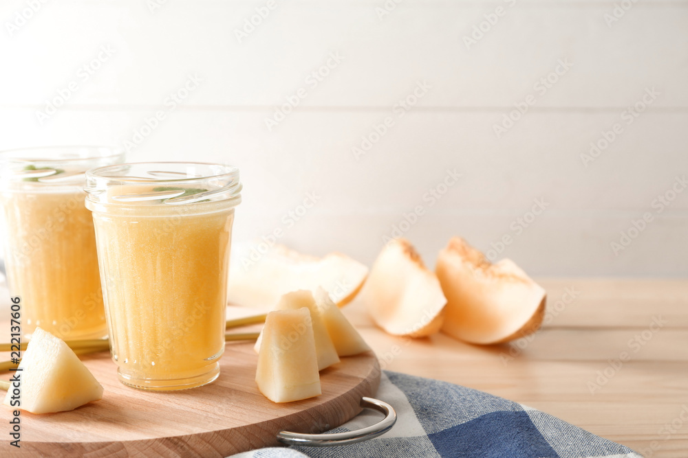 Glass jars with delicious melon smoothie on board