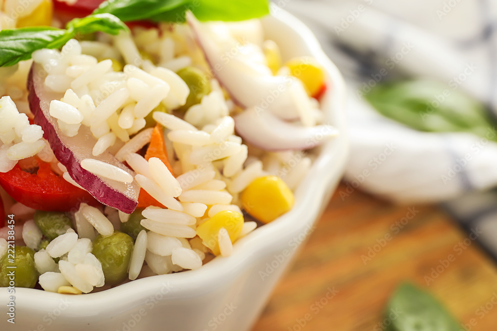 Bowl with tasty boiled rice and vegetables, closeup