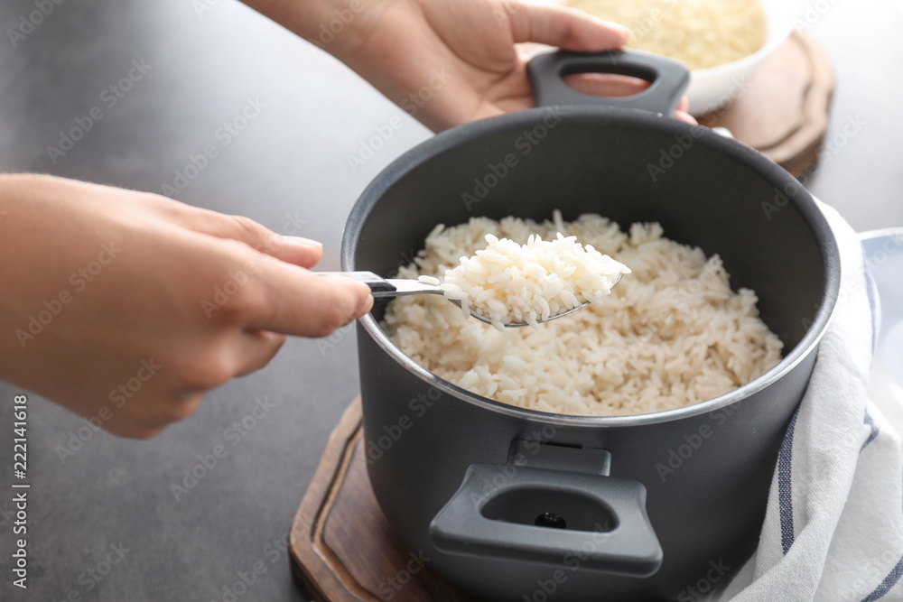 Woman with saucepan full of tasty rice