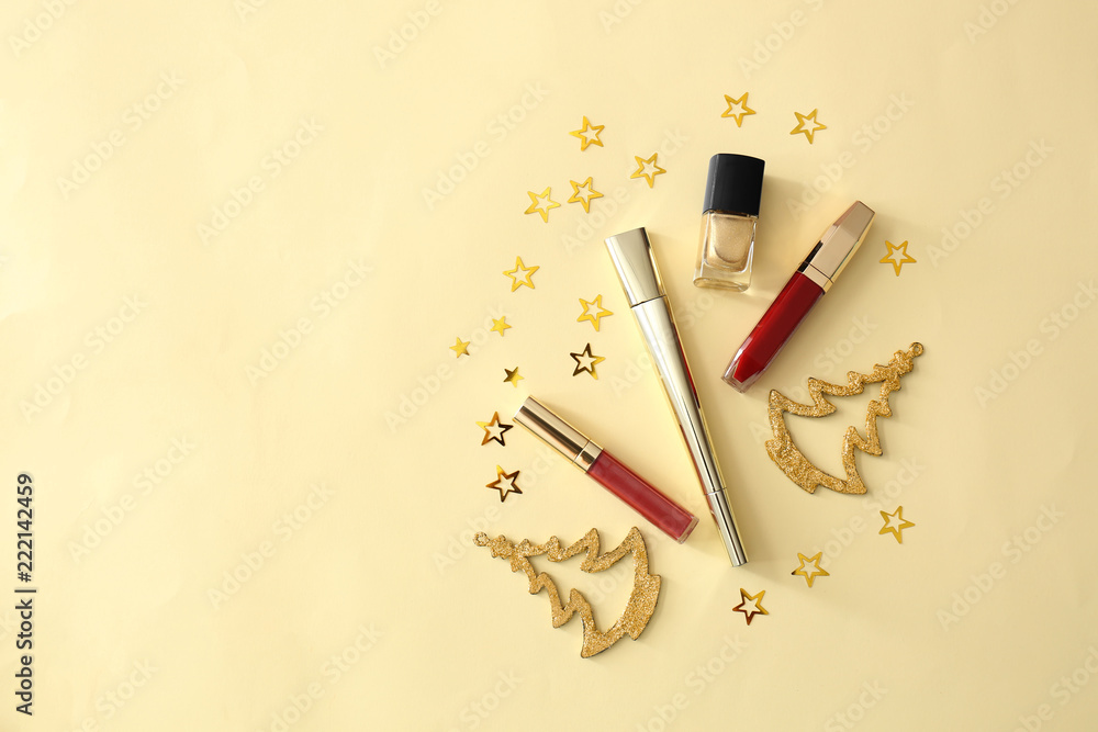 Set of cosmetics with Christmas decorations on color background