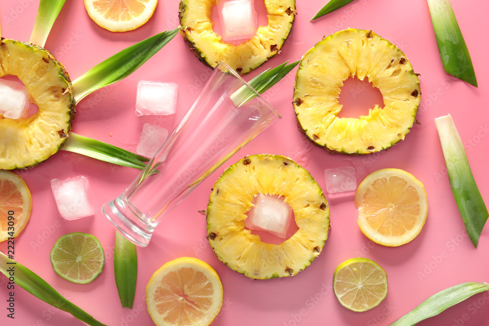 Composition with pineapple and empty glass on pink background