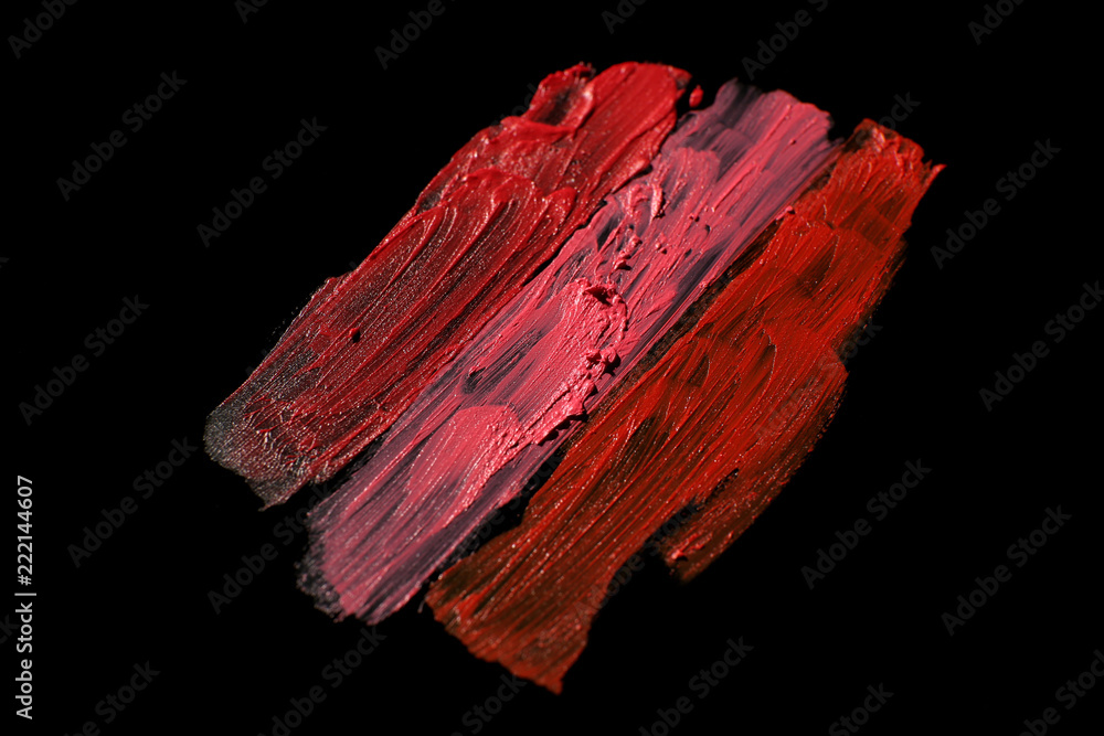 Strokes of color lipsticks on dark background