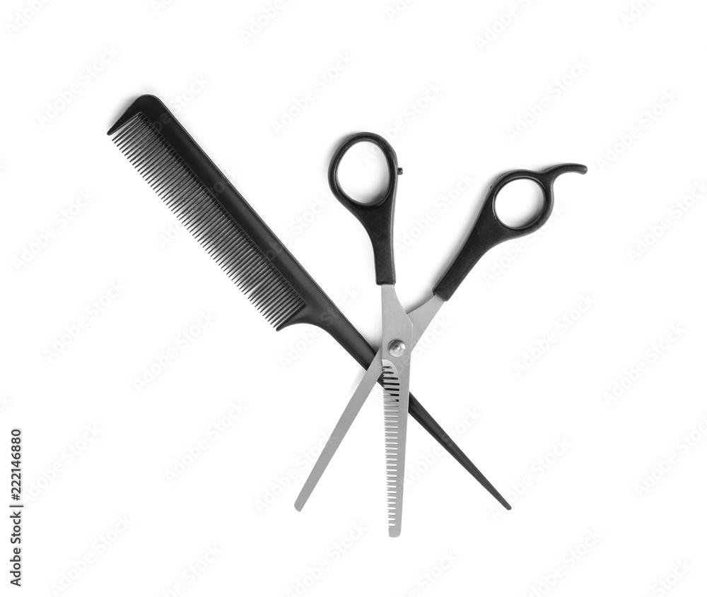 Professional hairdressers scissors and hair comb on white background